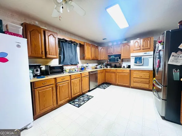 a kitchen with stainless steel appliances granite countertop a stove sink and cabinets