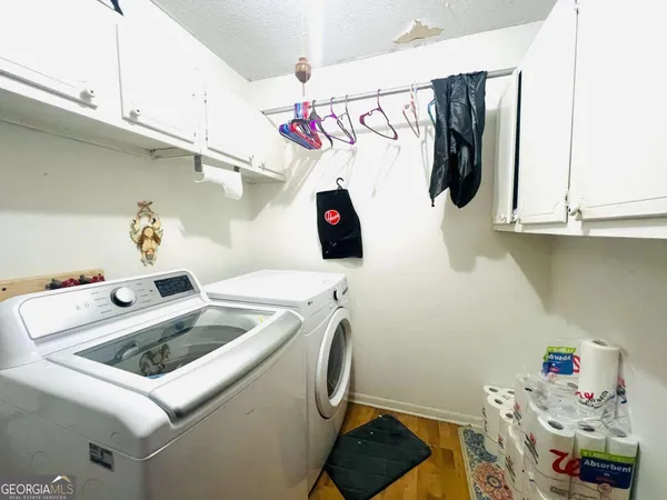 a utility room with sink and washing machine