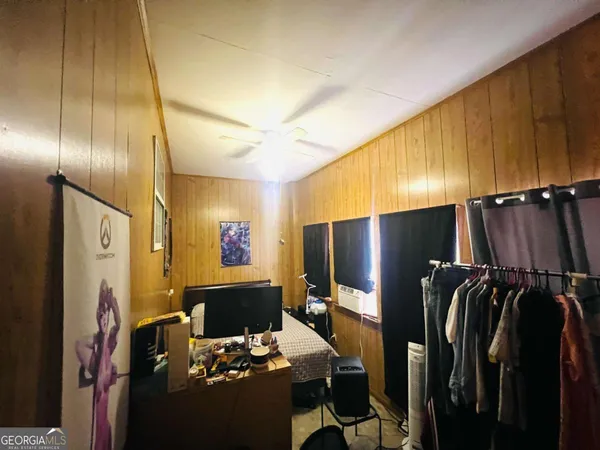 a bedroom with a bed and a desk