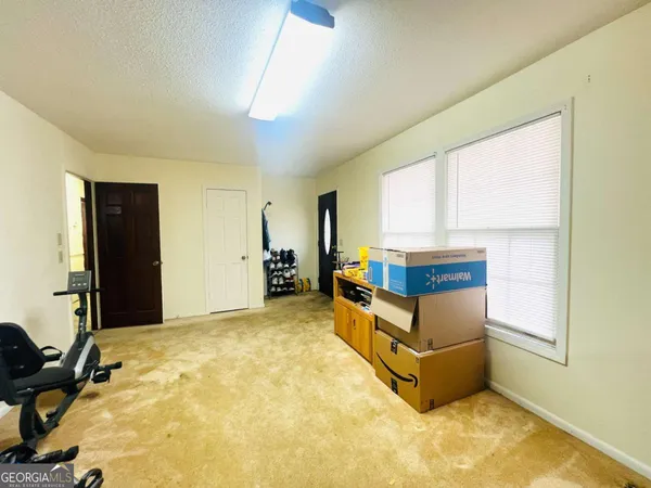 a living room with stainless steel appliances with furniture