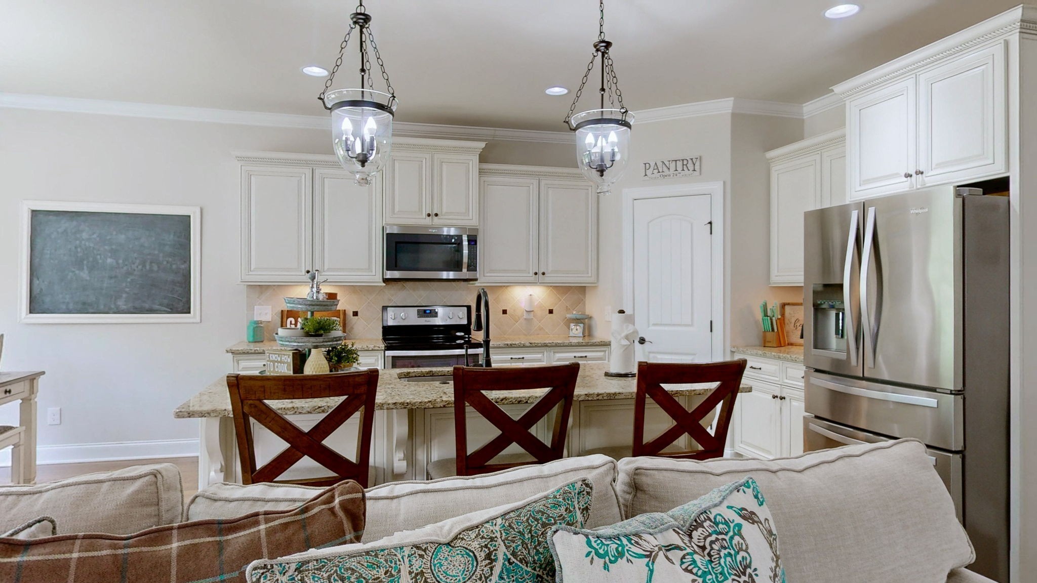 15505 Versailles Road Rockvale, TN 37153 - Photo 12 of 38 a kitchen with stainless steel appliances granite countertop a dining table chairs refrigerator and microwave