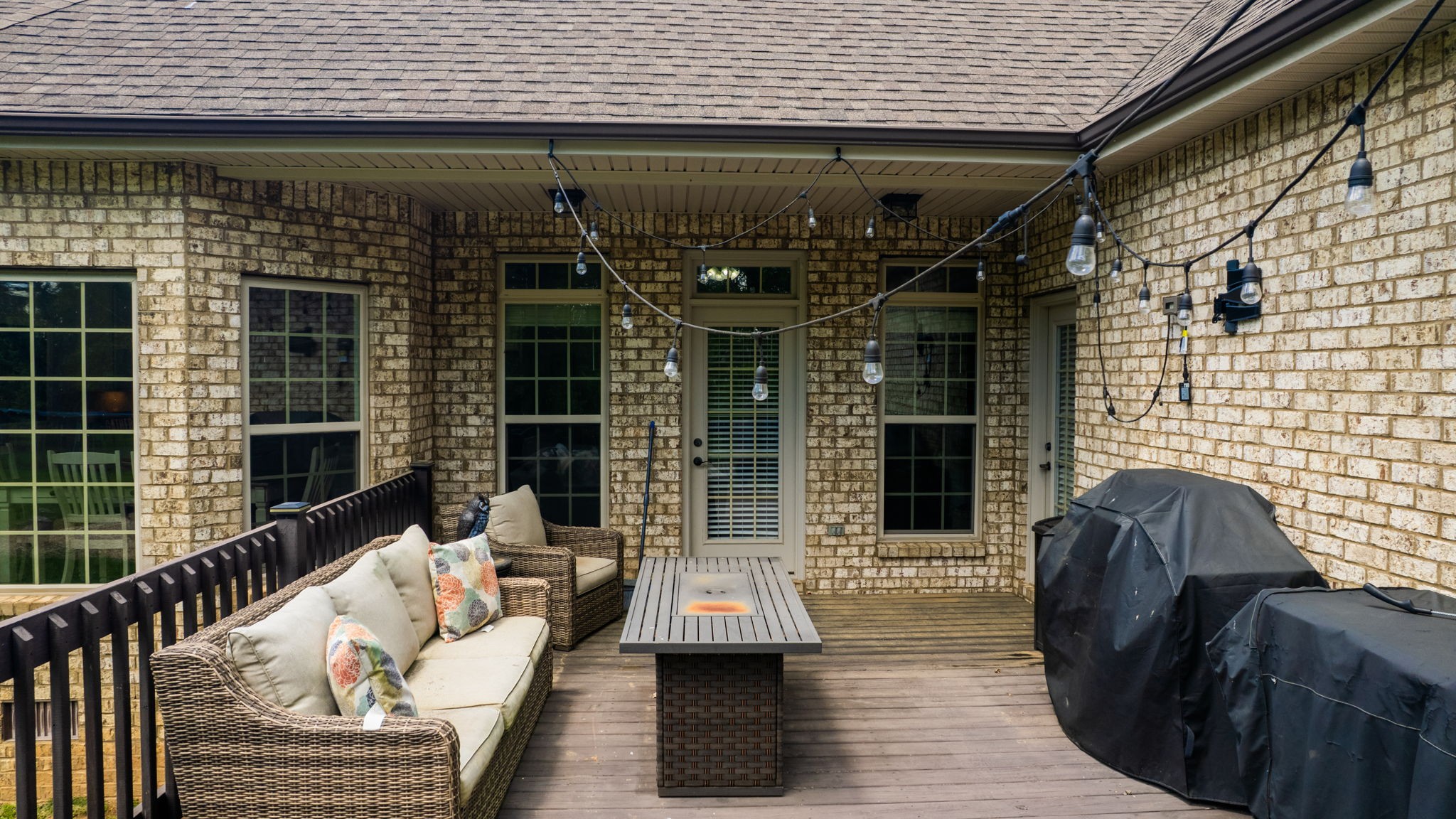 15505 Versailles Road Rockvale, TN 37153 - Photo 31 of 38 a view of a patio with couches table and chairs with wooden floor and fence