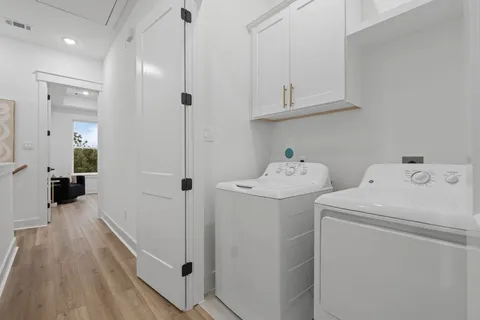 a bathroom with a sink and a washer dryer