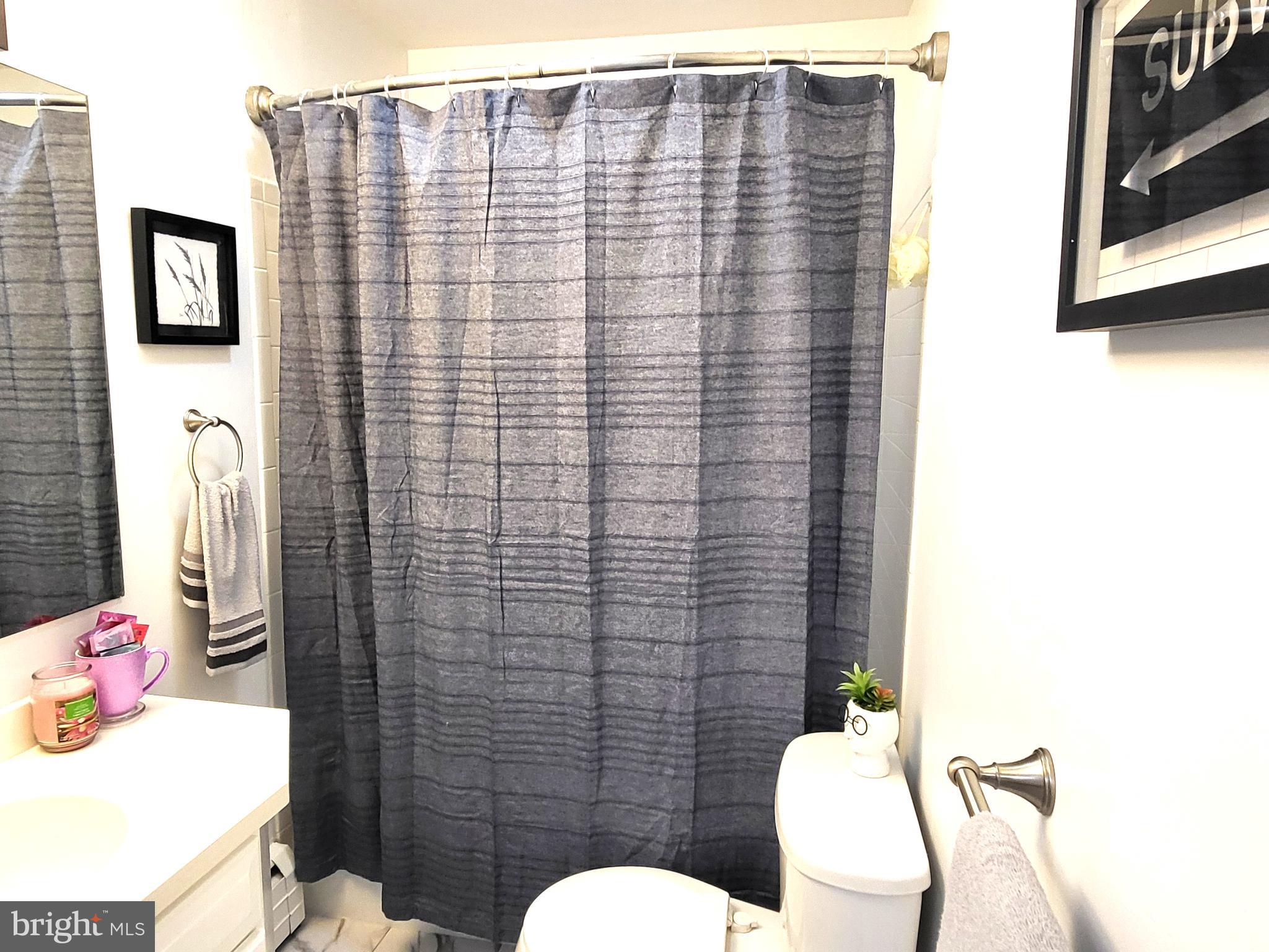 3408 Ridgeway Road Harrisburg, PA 17109 - Photo 27 of 40 a bathroom with a toilet sink and shower curtain