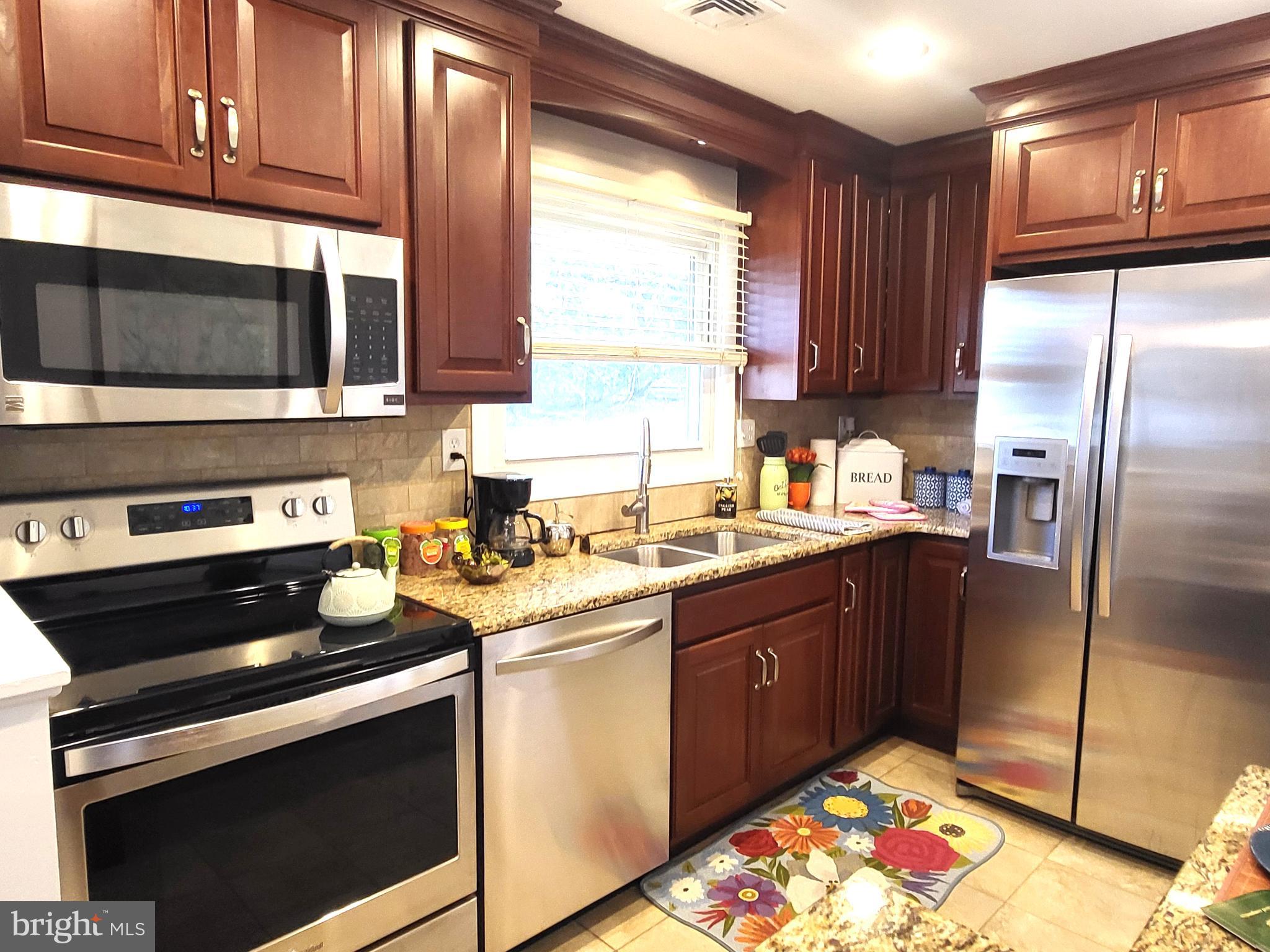 3408 Ridgeway Road Harrisburg, PA 17109 - Photo 7 of 40 a kitchen with stainless steel appliances granite countertop a sink stove and refrigerator