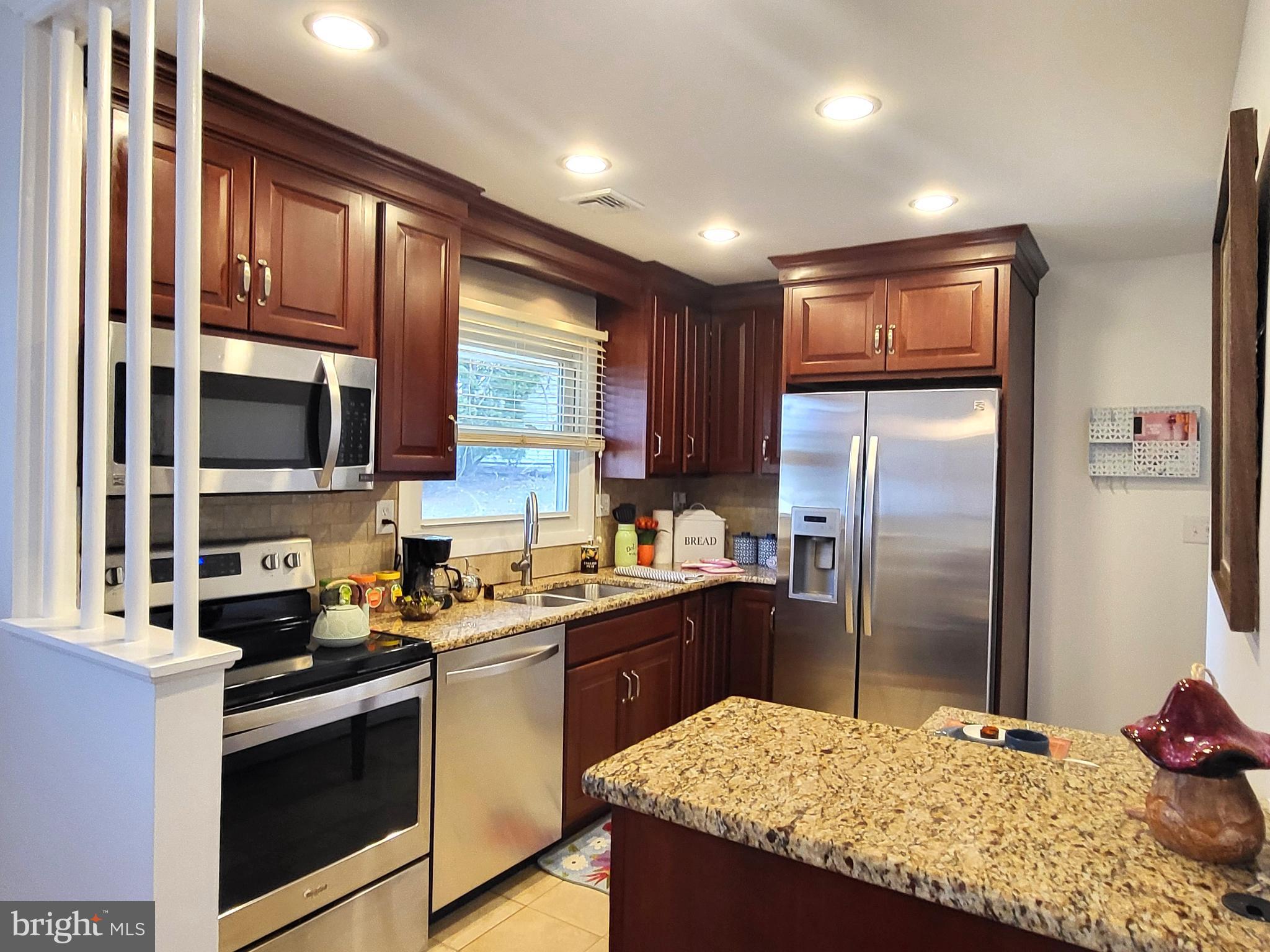 3408 Ridgeway Road Harrisburg, PA 17109 - Photo 8 of 40 a kitchen with stainless steel appliances granite countertop a refrigerator a stove a sink and a microwave