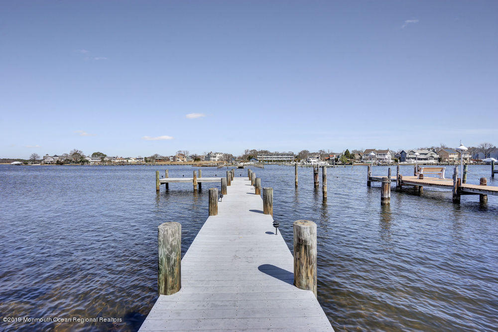566 Harbor Road Brick, NJ 08724 - Photo 11 of 100 a view of a lake with boats and trees in the background