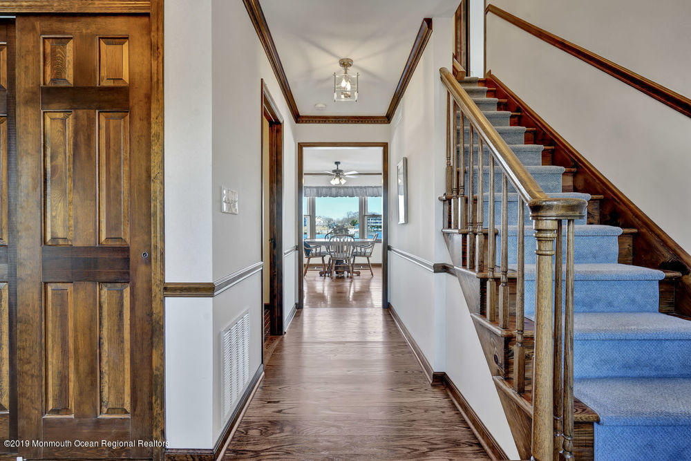 566 Harbor Road Brick, NJ 08724 - Photo 18 of 100 a view of staircase with lots of frames on wall and wooden floor