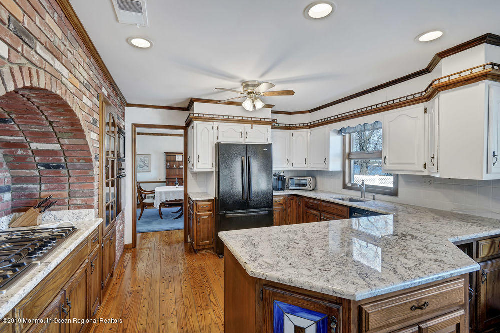 566 Harbor Road Brick, NJ 08724 - Photo 30 of 100 a kitchen with stainless steel appliances granite countertop a sink dishwasher stove and refrigerator with wooden floor