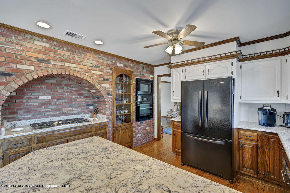 566 Harbor Road Brick, NJ 08724 - Photo 35 of 100 a kitchen with stainless steel appliances kitchen island a refrigerator sink and stove