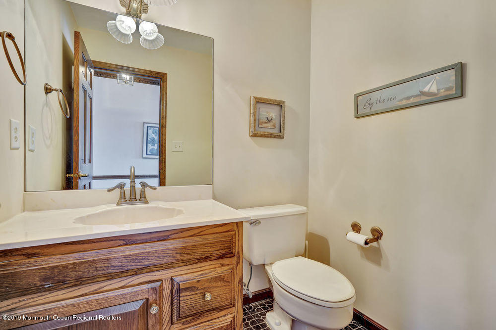 566 Harbor Road Brick, NJ 08724 - Photo 43 of 100 a bathroom with a sink a toilet a mirror and shower curtain