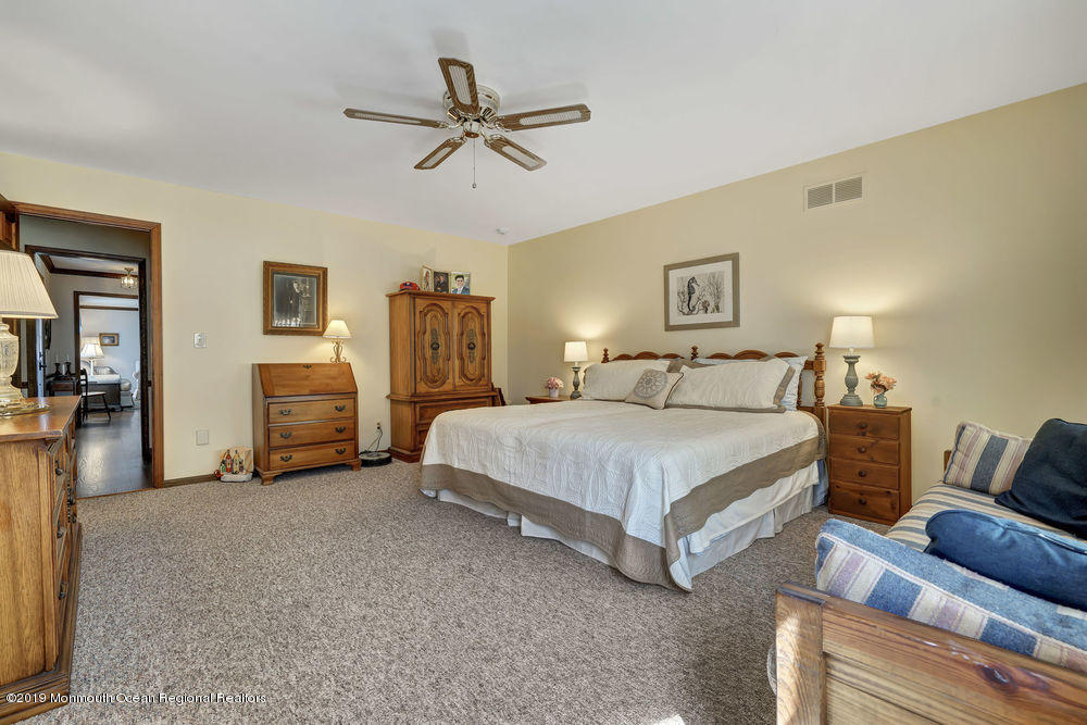 566 Harbor Road Brick, NJ 08724 - Photo 47 of 100 a spacious bedroom with a bed a couch and a chandelier