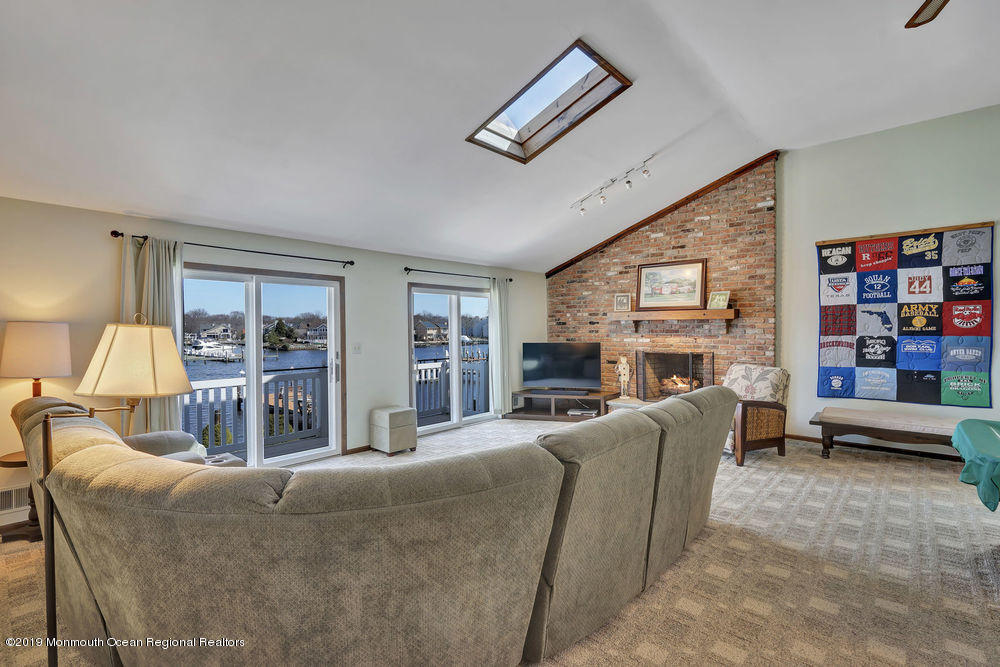 566 Harbor Road Brick, NJ 08724 - Photo 53 of 100 a living room with furniture a fireplace and a large window
