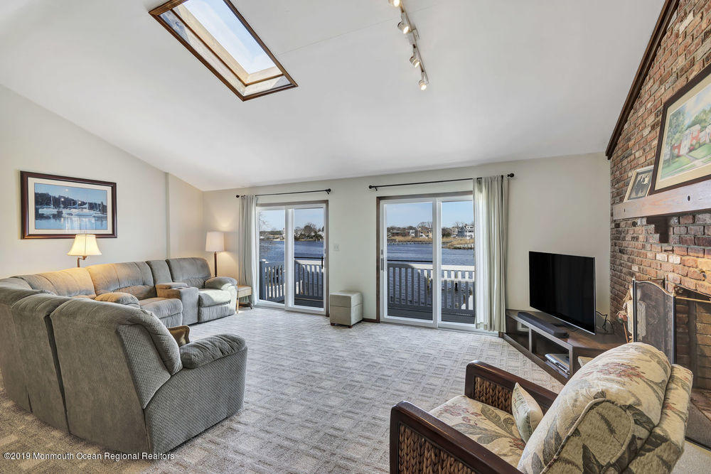566 Harbor Road Brick, NJ 08724 - Photo 54 of 100 a living room with furniture a flat screen tv and a large window