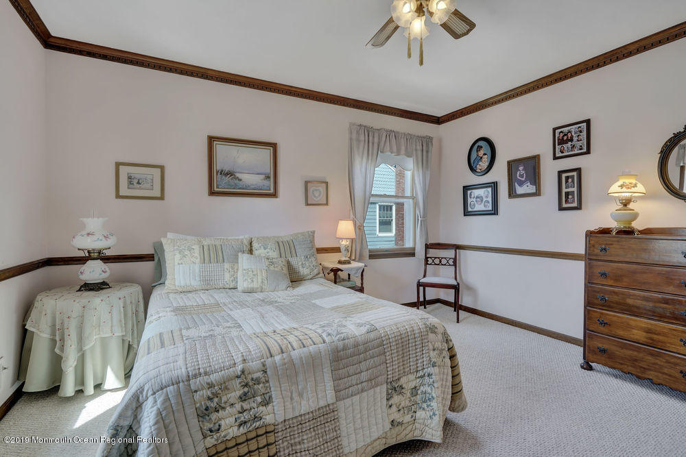 566 Harbor Road Brick, NJ 08724 - Photo 69 of 100 a bedroom with a bed and a chandelier