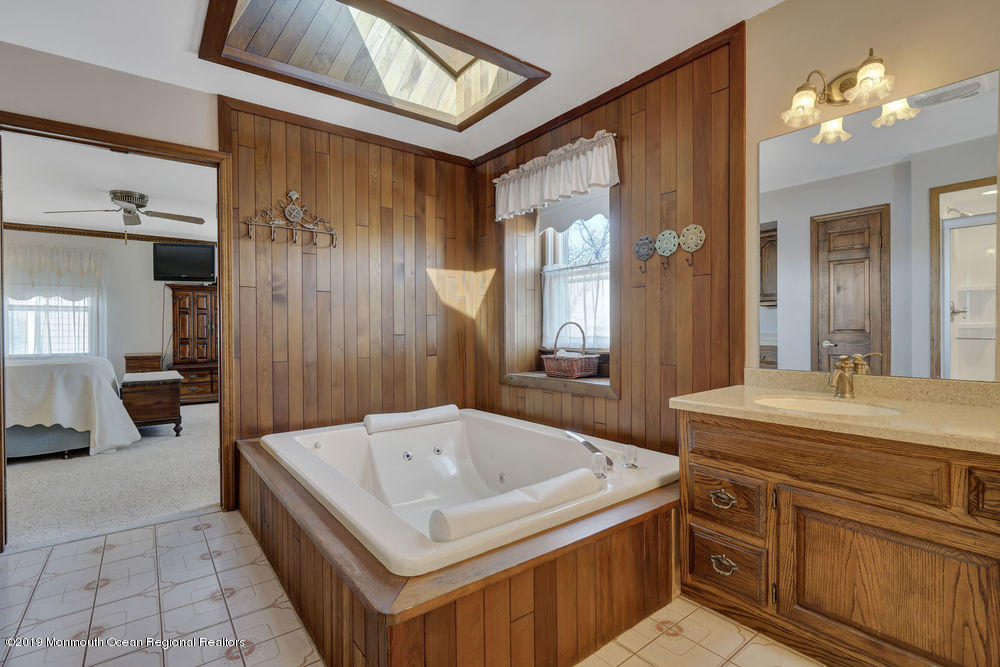 566 Harbor Road Brick, NJ 08724 - Photo 72 of 100 a bathroom with a tub a sink and mirrors