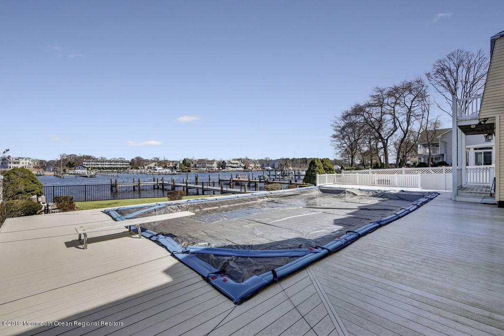 566 Harbor Road Brick, NJ 08724 - Photo 10 of 100 a view of a swimming pool with a lounge chair