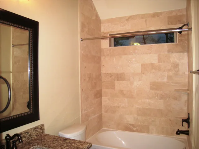 a bathroom with a shower and a sink