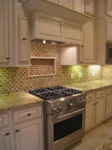 a kitchen with granite countertop a stove sink and cabinets
