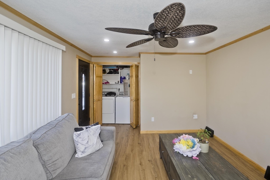 10 View Street Holyoke, MA 01040 - Photo 16 of 38 a bedroom with a bed and a chandelier