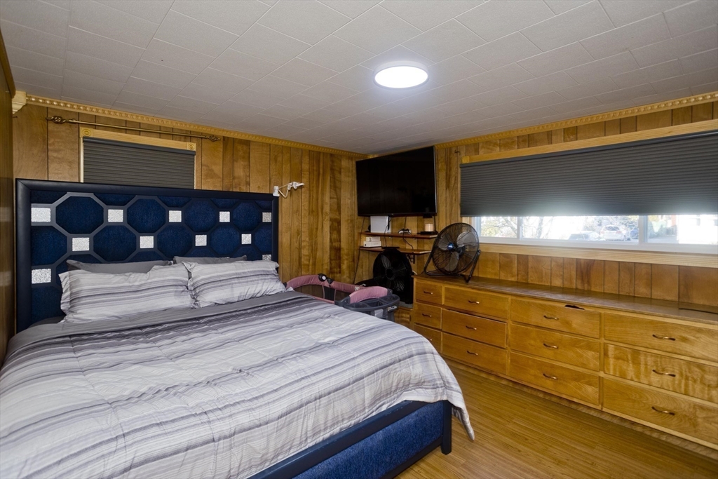 10 View Street Holyoke, MA 01040 - Photo 17 of 38 a bedroom with a bed a flat screen tv and dresser