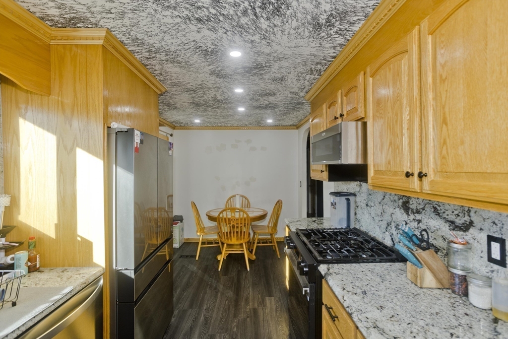 10 View Street Holyoke, MA 01040 - Photo 28 of 38 a kitchen with granite countertop sink stove and cabinets