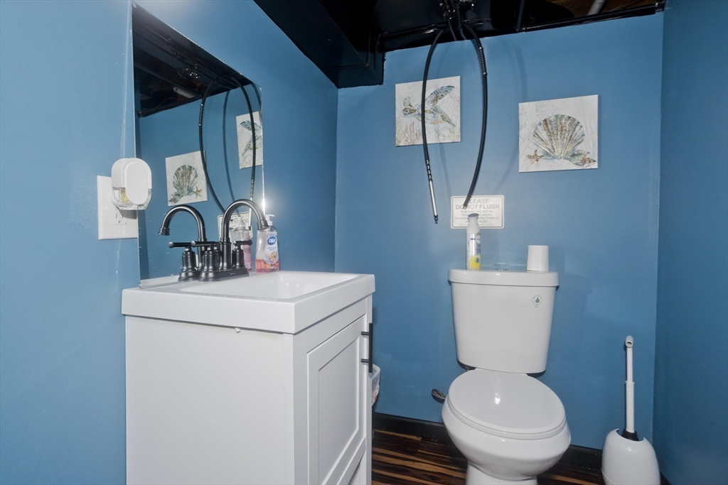 10 View Street Holyoke, MA 01040 - Photo 38 of 38 a bathroom with a toilet sink and mirror