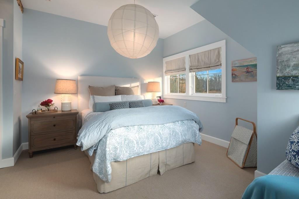 34 Martins Lane Hingham, MA 02043 - Photo 31 of 42 a spacious bedroom with a bed and a chandelier