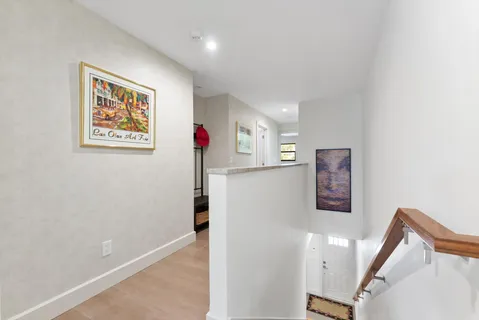 a bed sitting in a spacious bedroom next to a window
