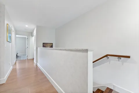 a bedroom with a bed a ceiling fan and a dresser