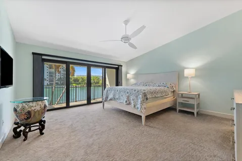 a bedroom with a bed and large window