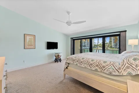 a bed sitting in a spacious bedroom next to a window