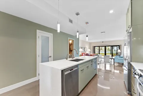 a kitchen with a sink stove and cabinets