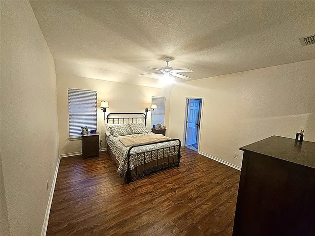 a bedroom with a bed and a night stand