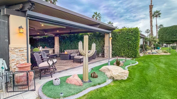 a swimming pool with outdoor seating and yard