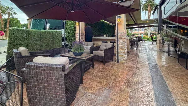 a view of an outdoor dining space with a table and chairs