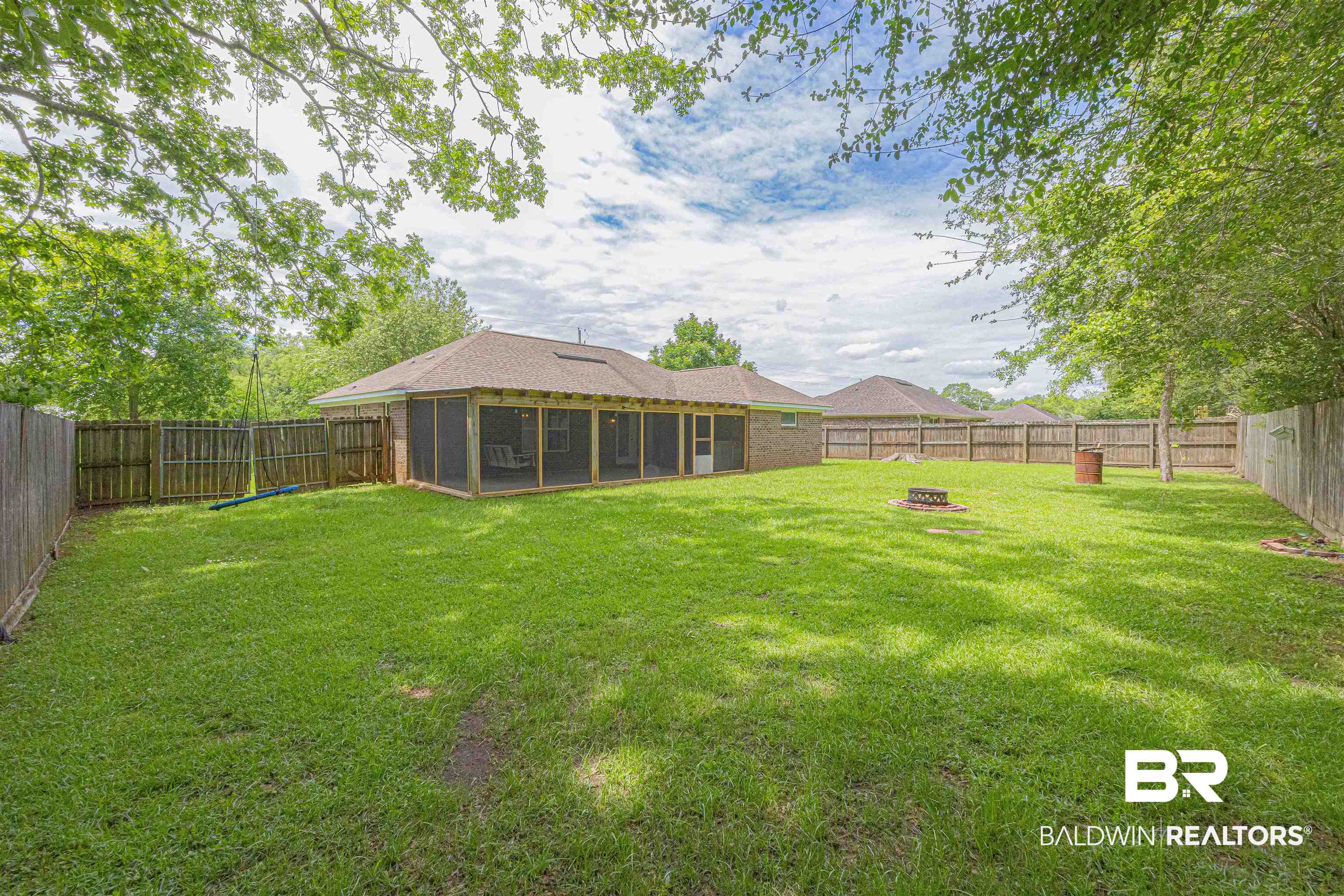 18675 Explorer Drive Loxley, AL 36551 - Photo 42 of 42 View of yard featuring a sunroom and a fire pit