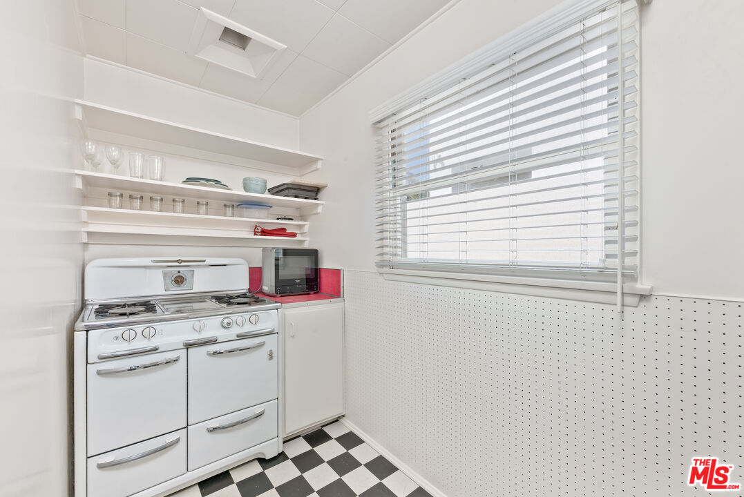 137 Strand Street Santa Monica, CA 90405 - Photo 4 of 11 a kitchen with stove cabinets and window