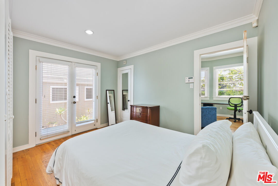 137 Strand Street Santa Monica, CA 90405 - Photo 6 of 11 a bedroom with a large bed and a large window