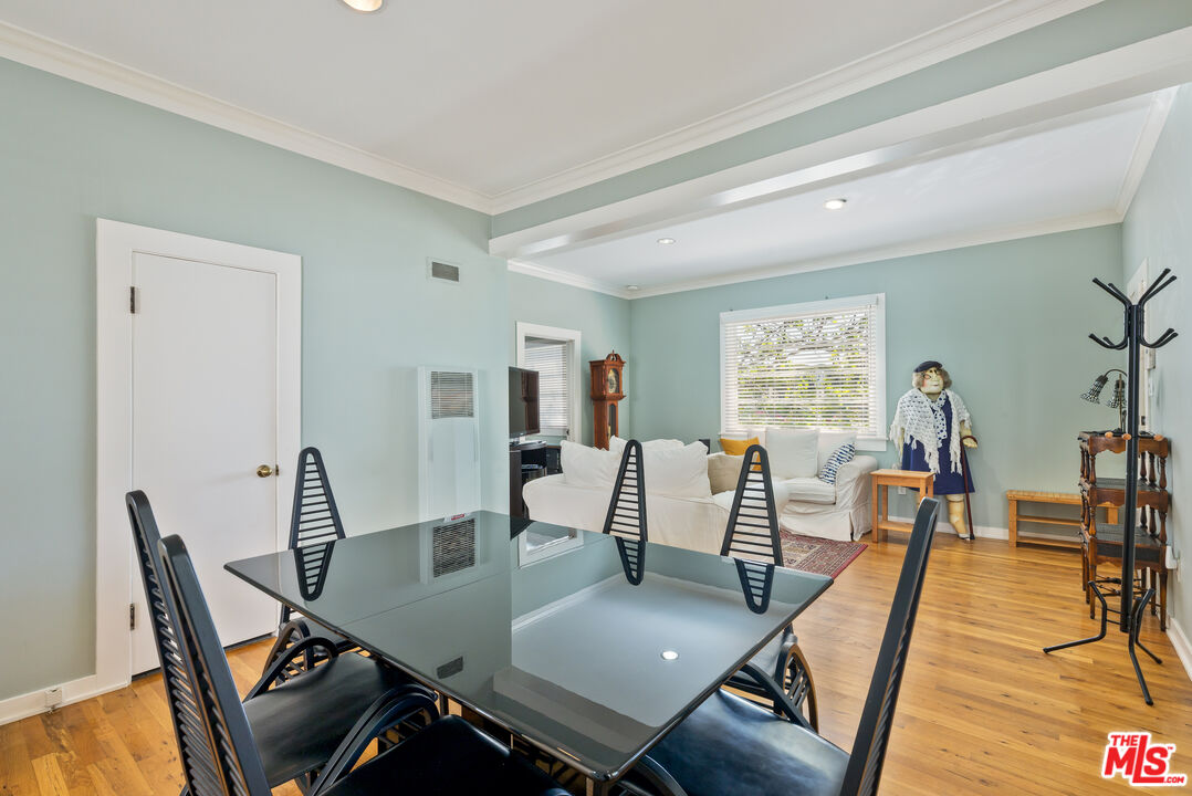 137 Strand Street Santa Monica, CA 90405 - Photo 9 of 11 a view of a dining room with furniture a chandelier and wooden floor