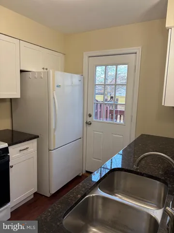 a kitchen with a refrigerator and a sink