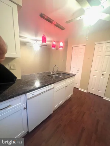 a kitchen with granite countertop a sink and a stove