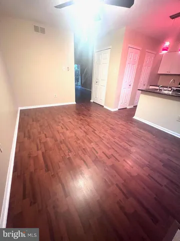 a view of a room with wooden floor