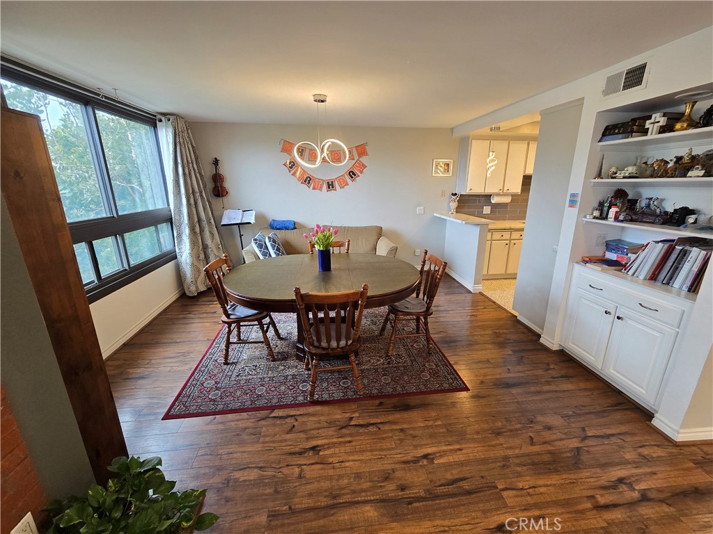 8828 Pershing Drive, Unit 121 Playa del Rey, CA 90293 - Photo 13 of 54 a view of a dining room with furniture window and wooden floor