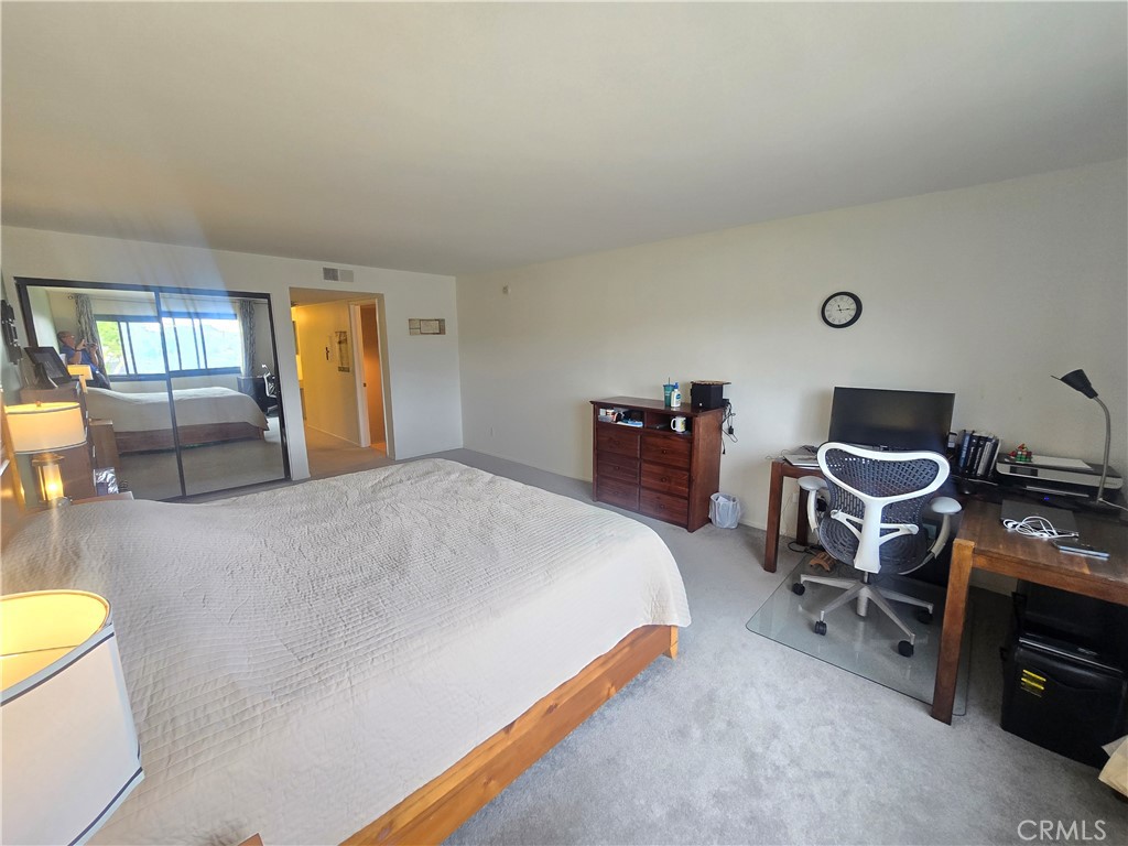 8828 Pershing Drive, Unit 121 Playa del Rey, CA 90293 - Photo 16 of 54 a bed room with a bed and a chair