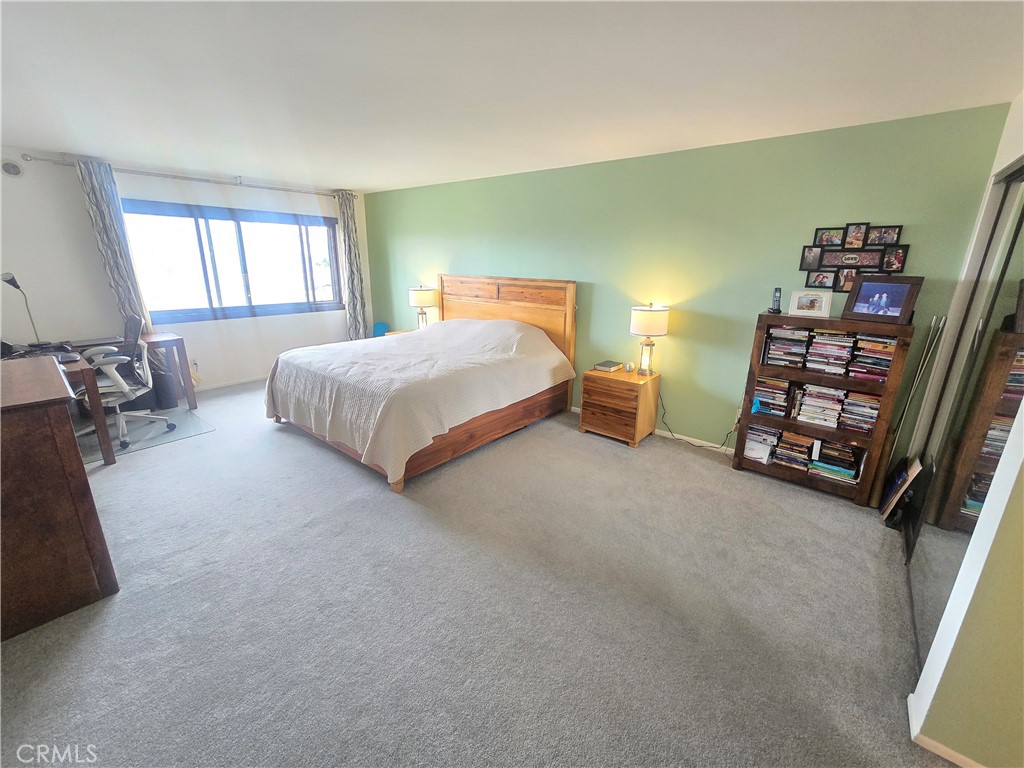 8828 Pershing Drive, Unit 121 Playa del Rey, CA 90293 - Photo 17 of 54 a spacious bedroom with a bed and a window