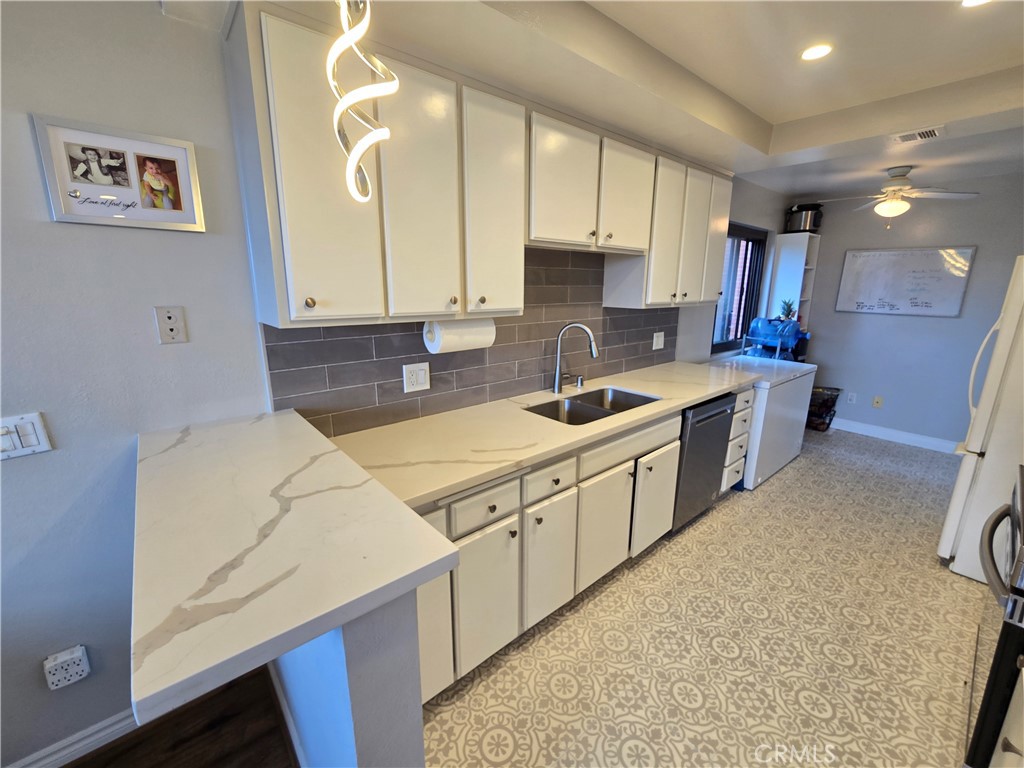8828 Pershing Drive, Unit 121 Playa del Rey, CA 90293 - Photo 2 of 54 a kitchen with stainless steel appliances granite countertop a sink a stove and a refrigerator