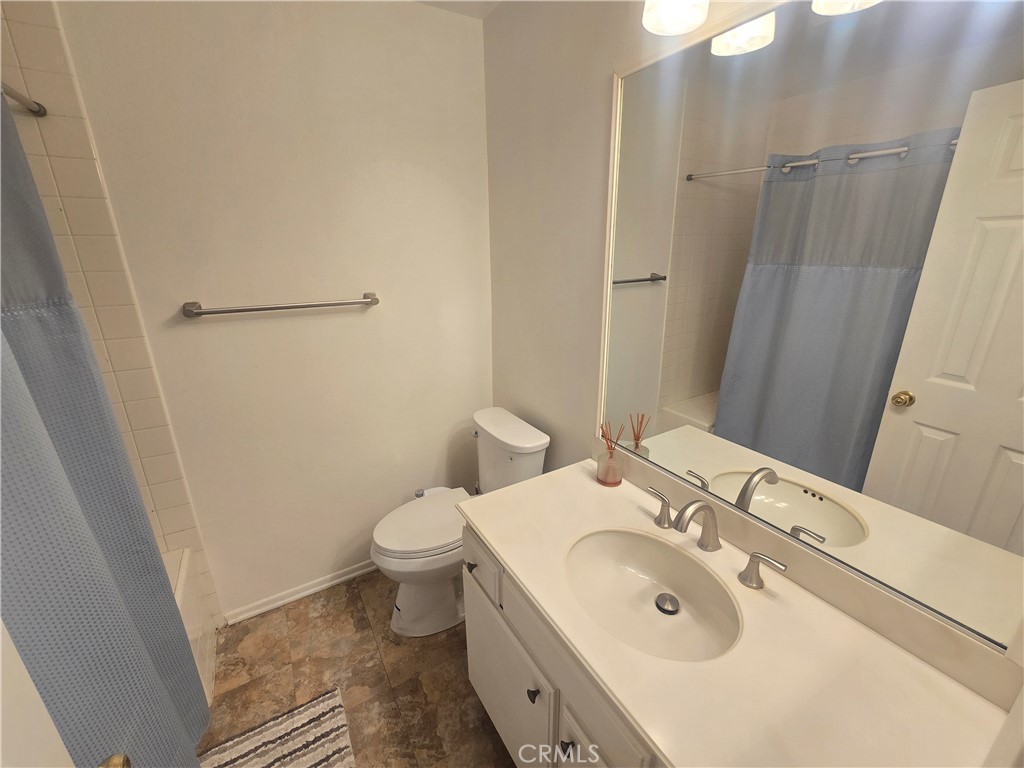 8828 Pershing Drive, Unit 121 Playa del Rey, CA 90293 - Photo 21 of 54 a bathroom with a sink and mirror with toilet