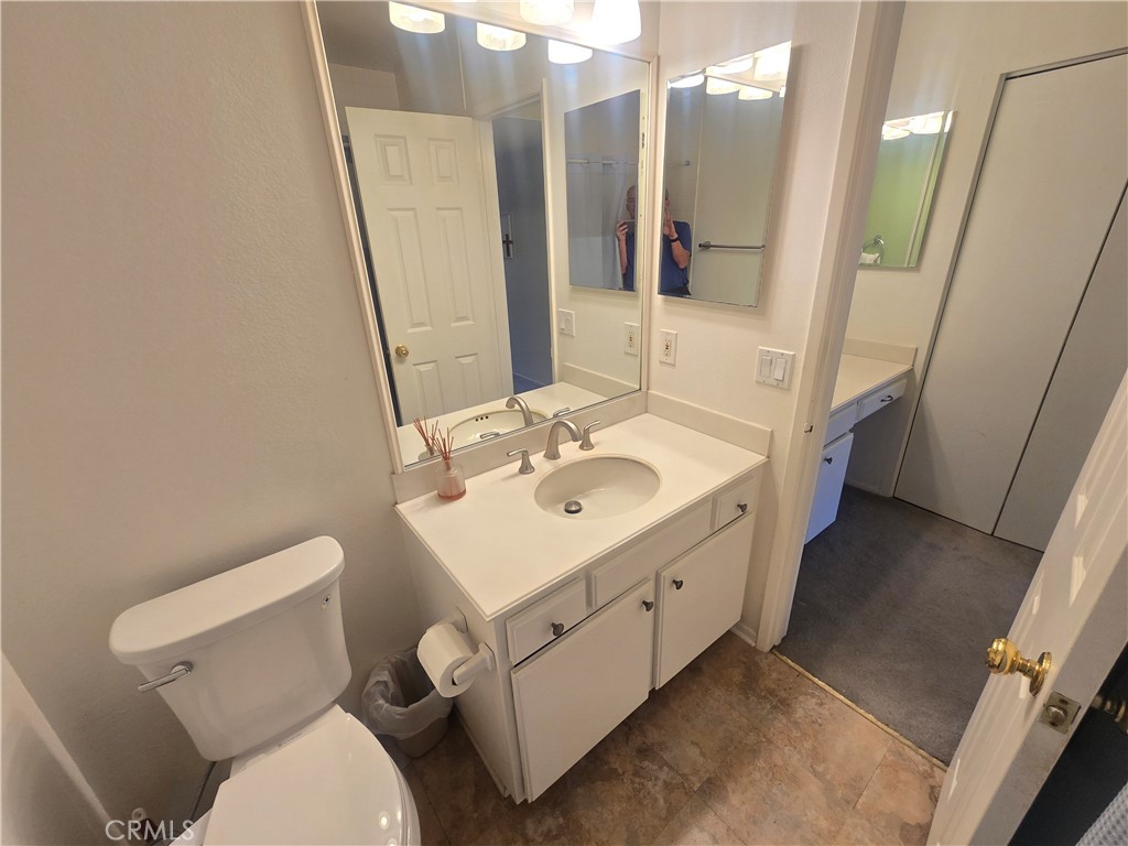 8828 Pershing Drive, Unit 121 Playa del Rey, CA 90293 - Photo 22 of 54 a bathroom with a sink a toilet a mirror and vanity