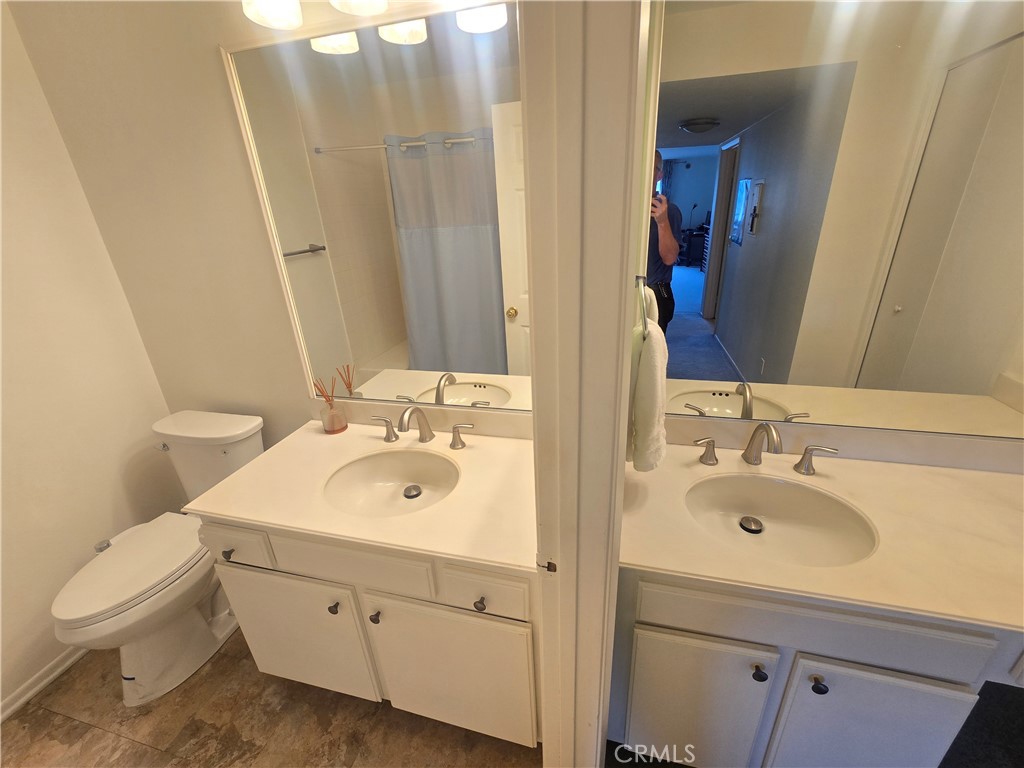 8828 Pershing Drive, Unit 121 Playa del Rey, CA 90293 - Photo 23 of 54 a bathroom with a sink toilet and mirror